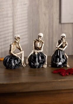 Set Of Three Resin Skeletons Sitting On LED Jack 'O Lanterns Decoration